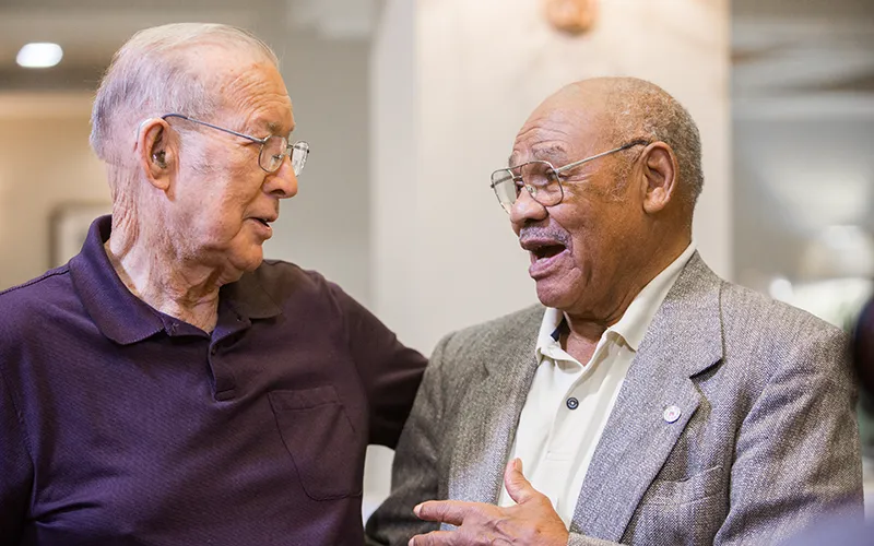 Two older men in conversation
