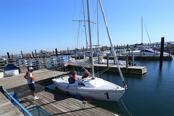 A small sailboat docked in a marina