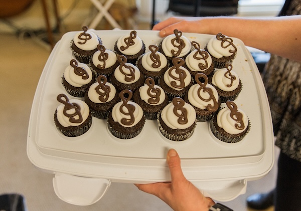 Chocolate cupcakes with white icing and chocolate trebel signs