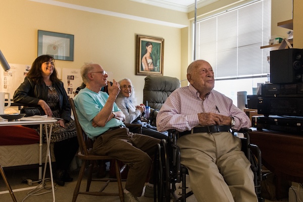 A group of older adults watches a music performance
