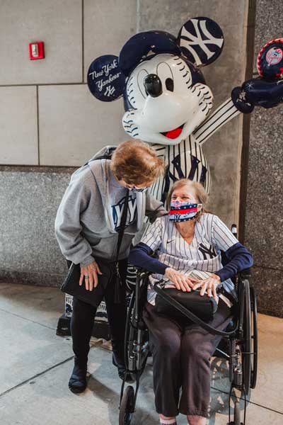 Alba and Vera pose with Mickey Mouse statue inside Yankee Stadium