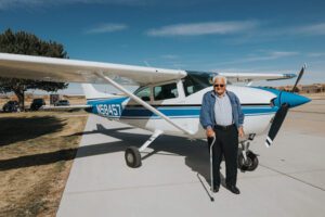 Wish recipient Heinz stands in front of Cessna airplane before his flight of a lifetime