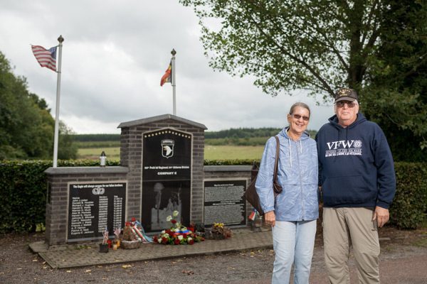 Rex and wife stand in front of WWII memorial at Jacks wood