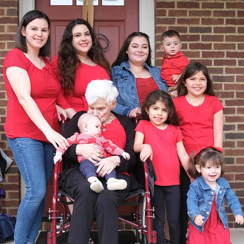 multiple generations of women in Pauline's family gather around her