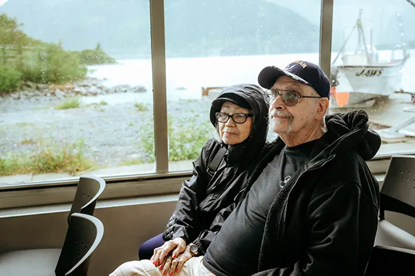 An older couple watches the scenery on a boat tour.