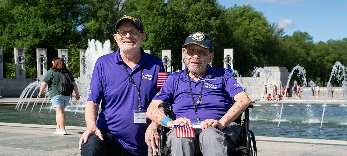 Two older men wearing Navy veteran hats visit Washington, D.C.
