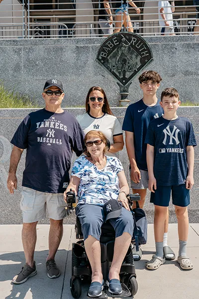 A family stands in front of a plaque honoring Babe Ruth.