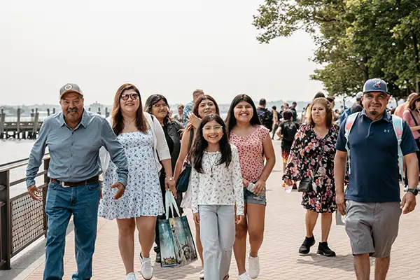 A family walks together along a harbor.