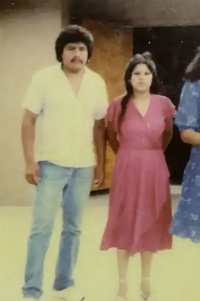 A young Mexican couple stands together in a vintage photograph.