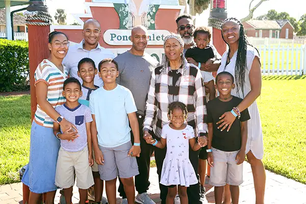 Three generations of an African American family stand together.
