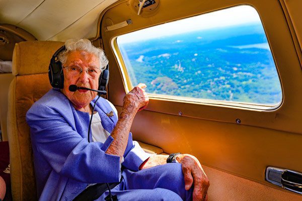 Anne points out the window of her airplane