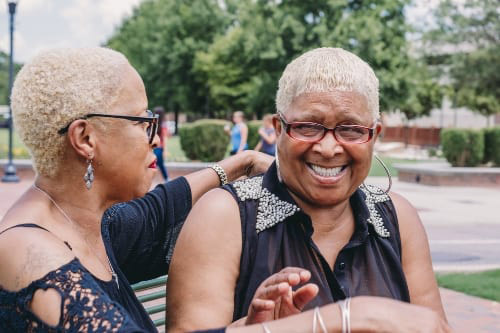 Two women in fun conversation in the park
