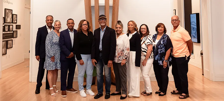 A large African American family poses for the camera at the Cultural Center Virginia.