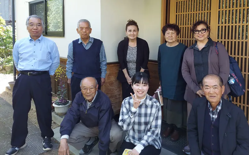 A group of Japanese people stand together.