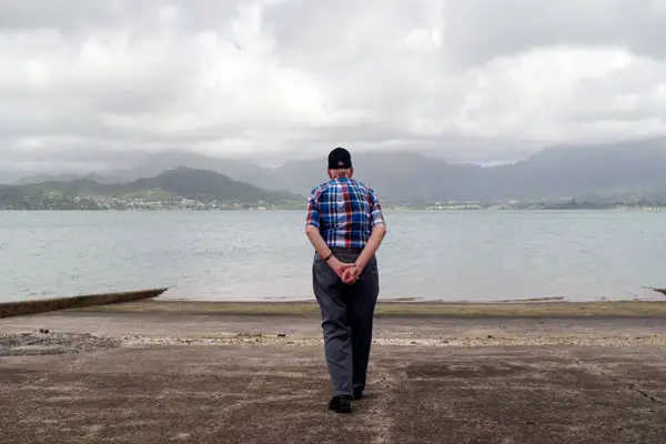 An older man looks out over Kaneohe Bay