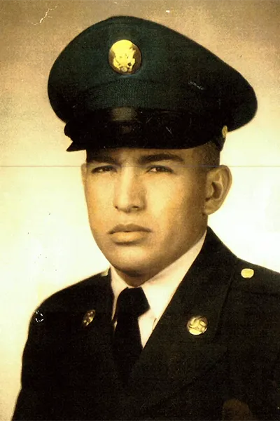 A vintage photo of an young man wearing an Army Service Uniform.