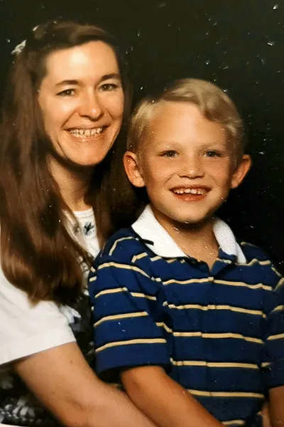 A mother and son appear in a vintage 1980s photo.