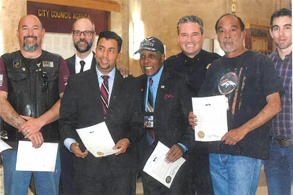 AARP-wish-national-siblings-day A group of military veterans stand together holding certificates.