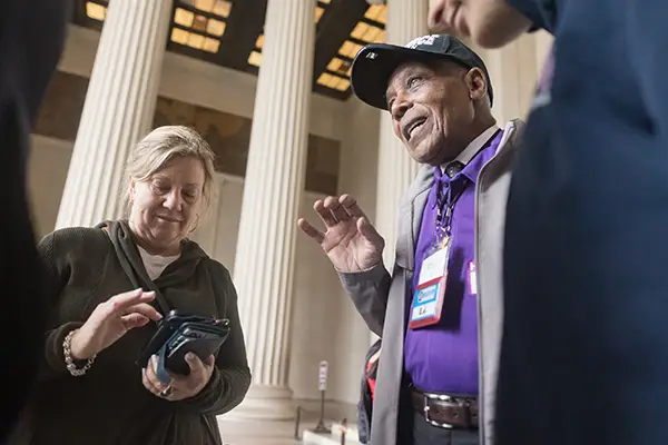 AARP-wish-national-siblings-day Three people talk near a Washington, D.C., monument.