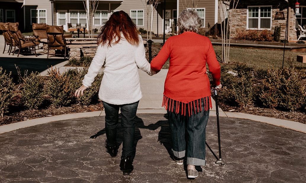 Natasha and mother walk together joyfully holding hands